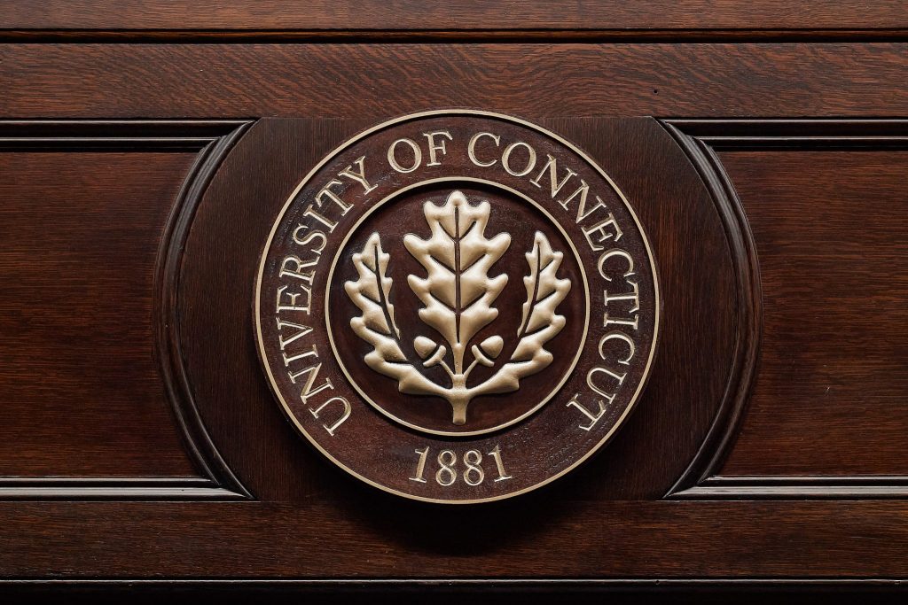 The University seal on woodwork in the Wilbur Cross building